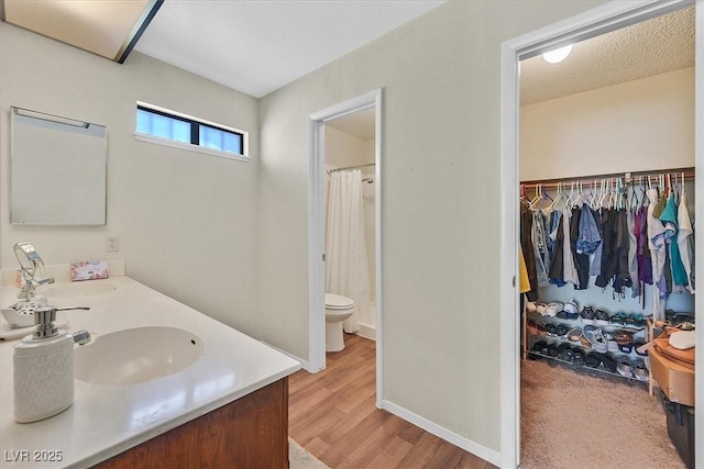 7113 Carrondale Way, Las Vegas, NV 89128 - full bathroom with vanity, wood finished floors, a shower with curtain, and a walk in closet
