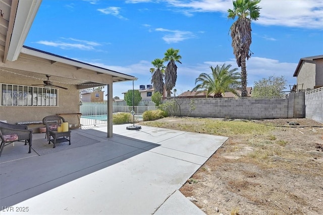 7113 Carrondale Way, Las Vegas, NV 89128 - fenced backyard with a ceiling fan and a patio