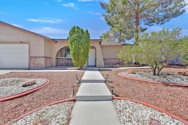 7113 Carrondale Way, Las Vegas, NV 89128 - view of front of home featuring stucco siding, brick siding, and an attached garage