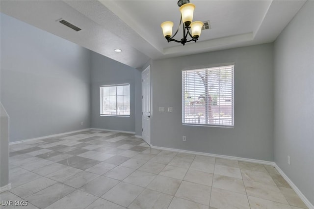 3941 Copper Stone Ct, North Las Vegas, NV 89032 - spare room with a chandelier, light tile patterned floors, and a tray ceiling