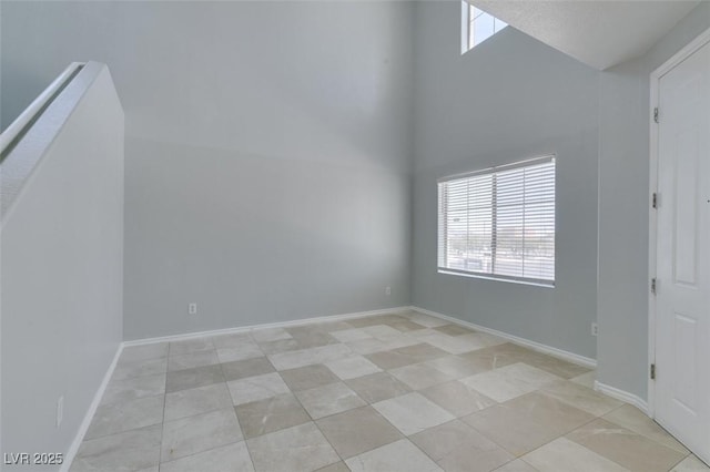 3941 Copper Stone Ct, North Las Vegas, NV 89032 - unfurnished room with healthy amount of natural light, light tile patterned floors, and a high ceiling