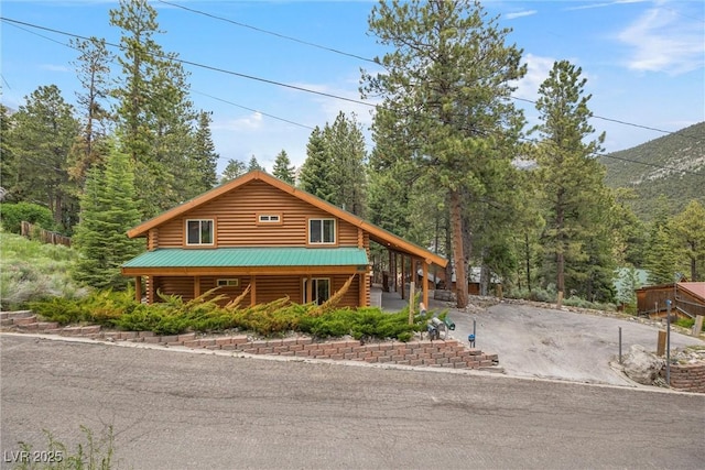 401 Alpine Way, Mount Charleston, NV 89124 - view of front of house with log exterior, stairs, and a forest view