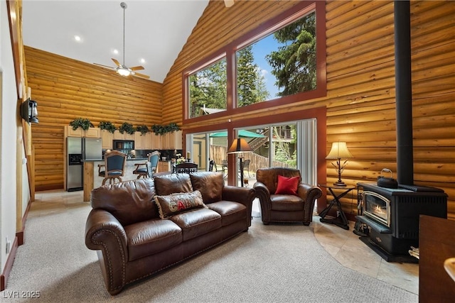 401 Alpine Way, Mount Charleston, NV 89124 - living area with high vaulted ceiling, a wood stove, a ceiling fan, log walls, and recessed lighting