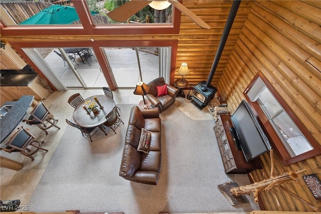 401 Alpine Way, Mount Charleston, NV 89124 - living room featuring a wood stove, log walls, and plenty of natural light