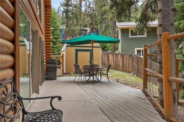 401 Alpine Way, Mount Charleston, NV 89124 - wooden terrace with a storage unit, outdoor dining space, grilling area, and a fenced backyard
