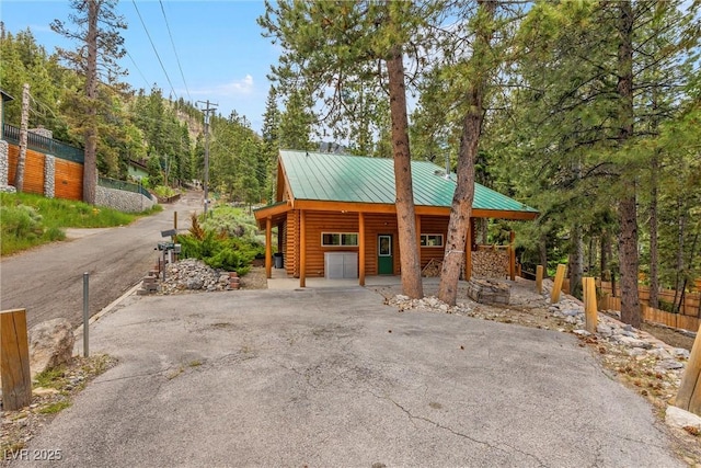 401 Alpine Way, Mount Charleston, NV 89124 - view of front of property with asphalt driveway, a metal roof, a standing seam roof, and log siding