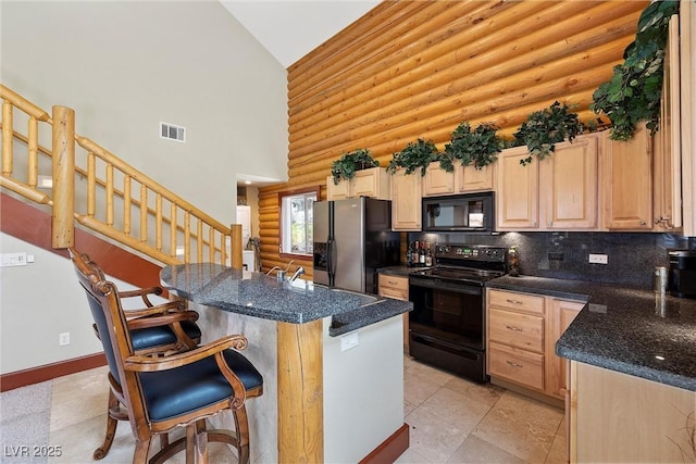 401 Alpine Way, Mount Charleston, NV 89124 - kitchen with black appliances, rustic walls, high vaulted ceiling, light brown cabinets, and a breakfast bar area