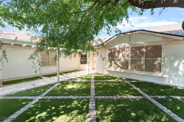 1723 Candice St, Las Vegas, NV 89156 - view of front facade featuring stucco siding and a front lawn