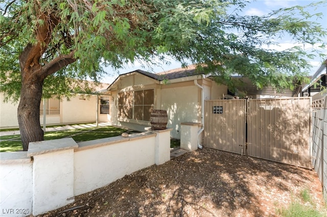 1723 Candice St, Las Vegas, NV 89156 - view of front facade featuring stucco siding and a gate