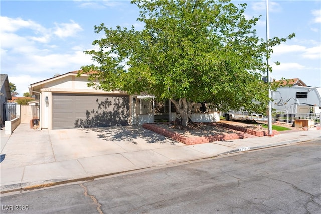 1723 Candice St, Las Vegas, NV 89156 - view of front of house with a garage, concrete driveway, and stucco siding
