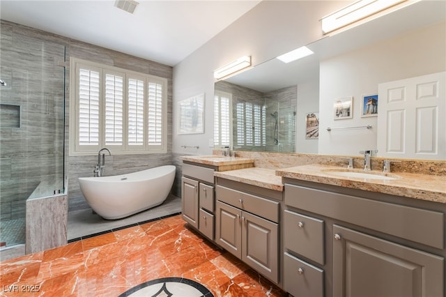 10331 Rio De Thule Ln, Las Vegas, NV 89135 - full bath featuring a shower stall, healthy amount of natural light, double vanity, a freestanding tub, and tile walls