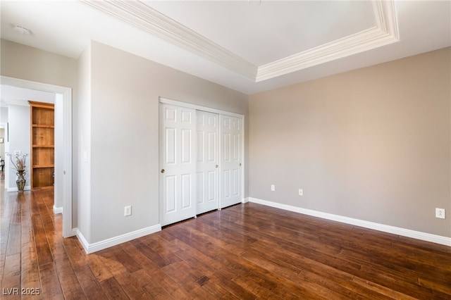 10331 Rio De Thule Ln, Las Vegas, NV 89135 - unfurnished bedroom with crown molding, dark wood-style floors, a tray ceiling, and a closet