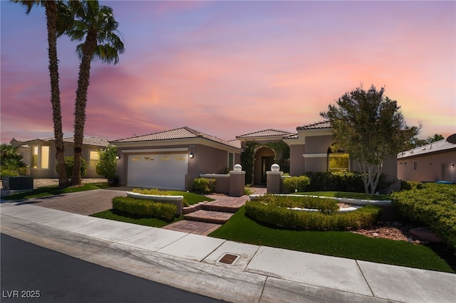 10331 Rio De Thule Ln, Las Vegas, NV 89135 - mediterranean / spanish-style home featuring decorative driveway, a tiled roof, stucco siding, and a garage