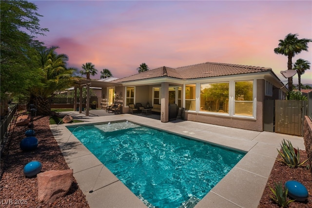 10331 Rio De Thule Ln, Las Vegas, NV 89135 - rear view of property featuring a patio area, a tiled roof, stucco siding, and an outdoor hangout area