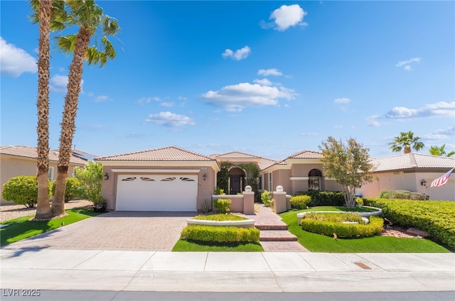 10331 Rio De Thule Ln, Las Vegas, NV 89135 - mediterranean / spanish-style house with driveway, an attached garage, stucco siding, and a tile roof