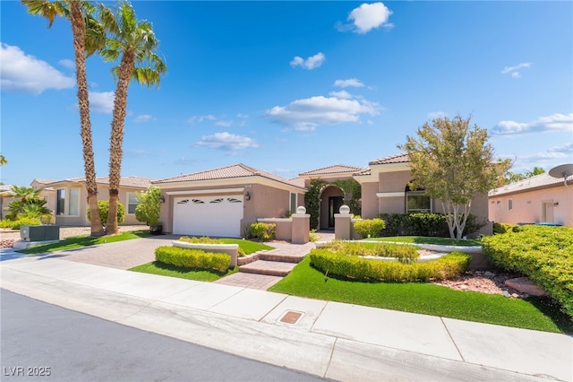 10331 Rio De Thule Ln, Las Vegas, NV 89135 - mediterranean / spanish house with a tile roof, stucco siding, decorative driveway, and an attached garage