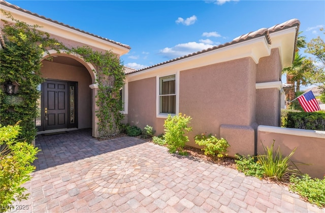 10331 Rio De Thule Ln, Las Vegas, NV 89135 - view of exterior entry featuring stucco siding and a tile roof