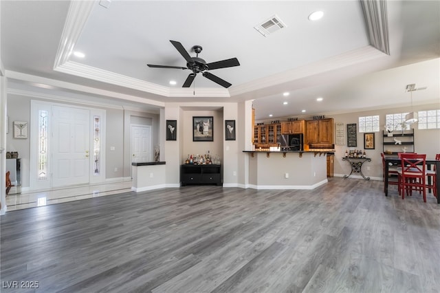 10331 Rio De Thule Ln, Las Vegas, NV 89135 - living room with a tray ceiling, crown molding, recessed lighting, a ceiling fan, and wood finished floors