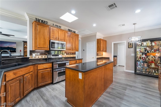 10331 Rio De Thule Ln, Las Vegas, NV 89135 - kitchen featuring stainless steel appliances, crown molding, backsplash, brown cabinetry, and a center island