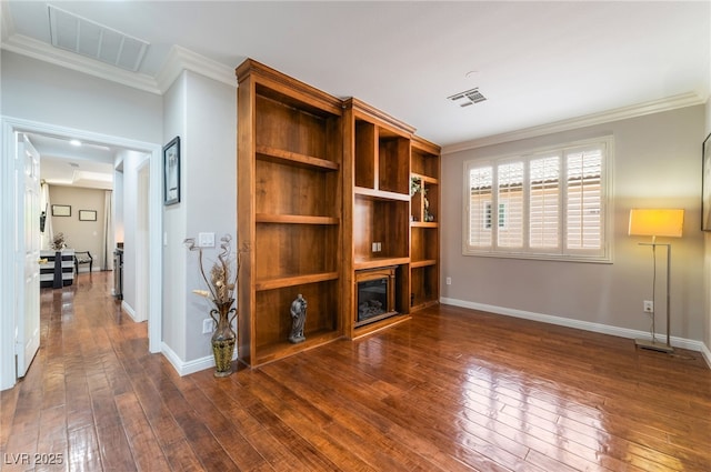 10331 Rio De Thule Ln, Las Vegas, NV 89135 - unfurnished living room with crown molding, dark wood finished floors, and a glass covered fireplace