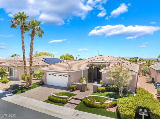 10331 Rio De Thule Ln, Las Vegas, NV 89135 - view of front of house with an attached garage, stucco siding, a tiled roof, and driveway