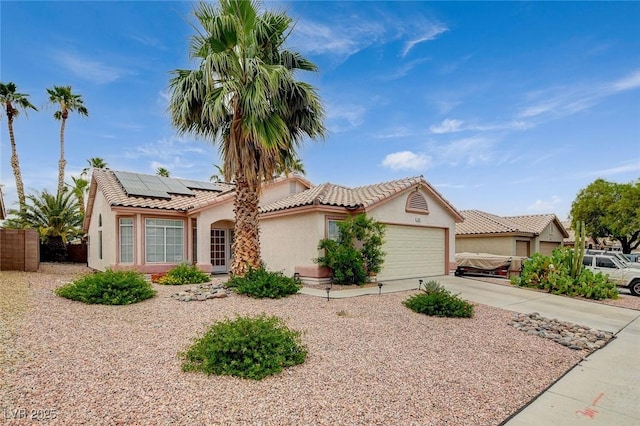 1981 Spring Lake Dr, Henderson, NV 89002 - ranch-style home with stucco siding, an attached garage, roof mounted solar panels, concrete driveway, and a tiled roof