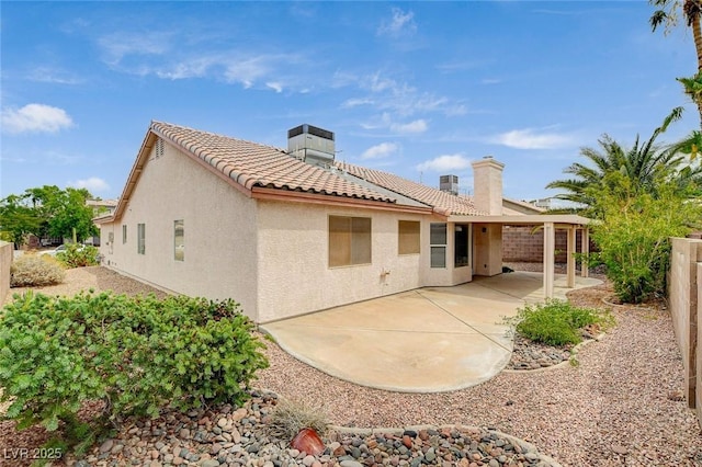 1981 Spring Lake Dr, Henderson, NV 89002 - back of house featuring a tiled roof, a patio, a chimney, stucco siding, and a fenced backyard