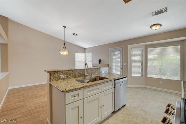 1981 Spring Lake Dr, Henderson, NV 89002 - kitchen featuring stainless steel dishwasher, hanging light fixtures, light stone counters, an island with sink, and lofted ceiling