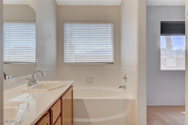 1981 Spring Lake Dr, Henderson, NV 89002 - bathroom featuring a garden tub, double vanity, and plenty of natural light