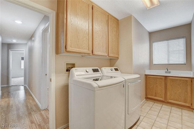 1981 Spring Lake Dr, Henderson, NV 89002 - washroom featuring washer and clothes dryer, cabinet space, and light wood-style flooring