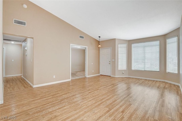 1981 Spring Lake Dr, Henderson, NV 89002 - spare room featuring light wood-type flooring and high vaulted ceiling