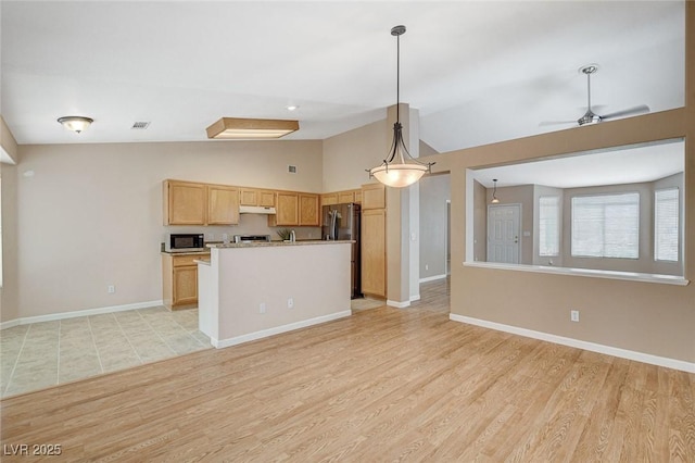 1981 Spring Lake Dr, Henderson, NV 89002 - kitchen featuring open floor plan, freestanding refrigerator, lofted ceiling, under cabinet range hood, and light wood-type flooring