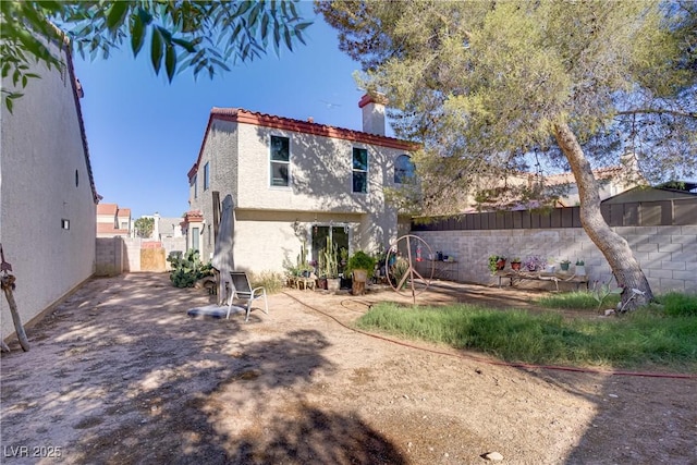 117 Lotus Blossom Ct, Las Vegas, NV 89145 - back of house with a chimney, a fenced backyard, and stucco siding