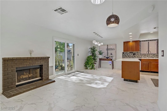 117 Lotus Blossom Ct, Las Vegas, NV 89145 - living area featuring light marble finish flooring, a brick fireplace, and recessed lighting
