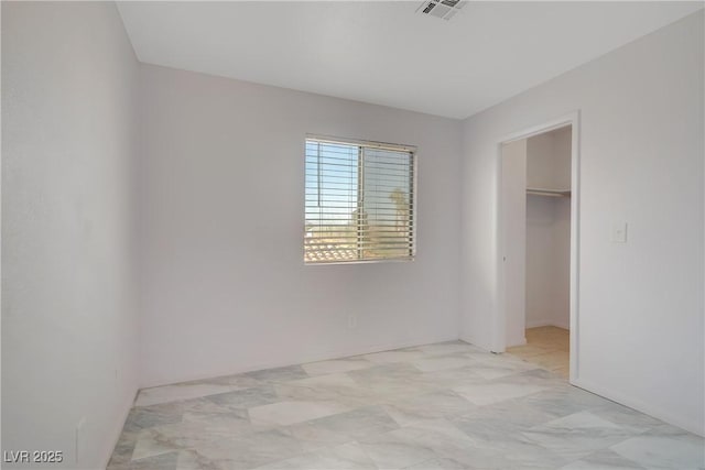 117 Lotus Blossom Ct, Las Vegas, NV 89145 - unfurnished bedroom featuring a walk in closet, a closet, and light marble finish flooring