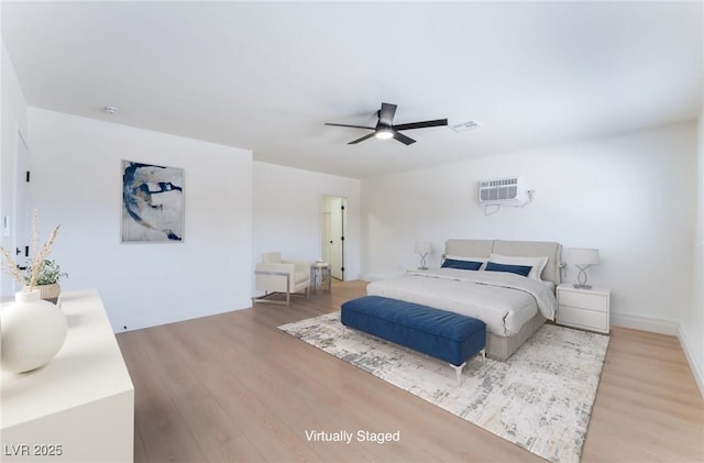 313 Agora Way, Las Vegas, NV 89110 - bedroom with light wood-style flooring, a wall unit AC, and a ceiling fan