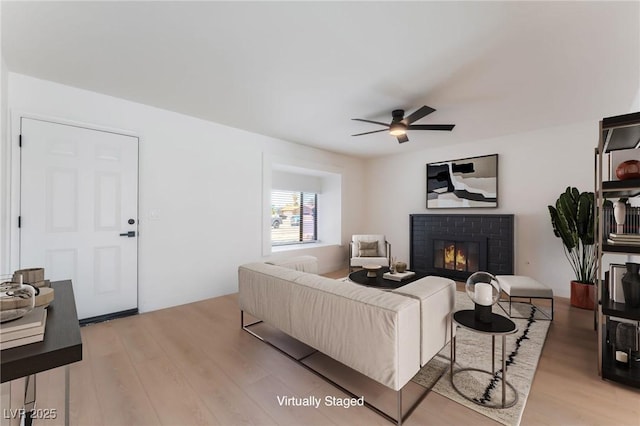 313 Agora Way, Las Vegas, NV 89110 - living room with light wood-style floors, a ceiling fan, and a brick fireplace