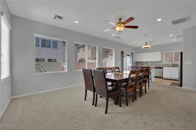 9131 Grand Sunburst Ct, Las Vegas, NV 89149 - dining room featuring healthy amount of natural light, a ceiling fan, recessed lighting, and light colored carpet