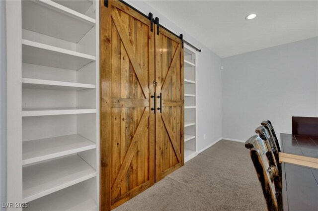 9131 Grand Sunburst Ct, Las Vegas, NV 89149 - carpeted home office with a barn door and recessed lighting