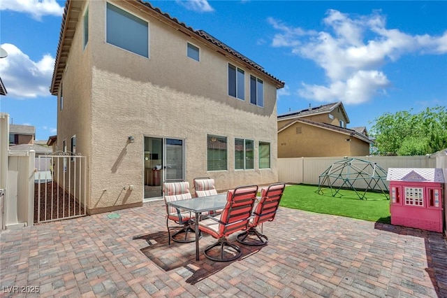 9131 Grand Sunburst Ct, Las Vegas, NV 89149 - fenced backyard with a patio, a gate, and outdoor dining space