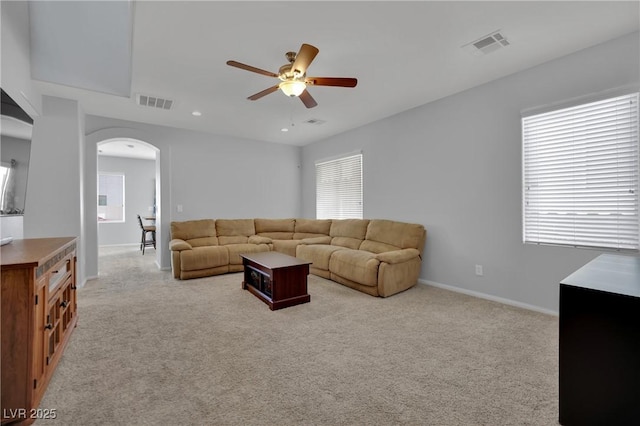 9131 Grand Sunburst Ct, Las Vegas, NV 89149 - living room with arched walkways, a ceiling fan, light carpet, and recessed lighting