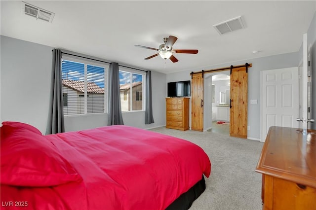 9131 Grand Sunburst Ct, Las Vegas, NV 89149 - bedroom featuring a barn door, carpet, ensuite bath, and a ceiling fan