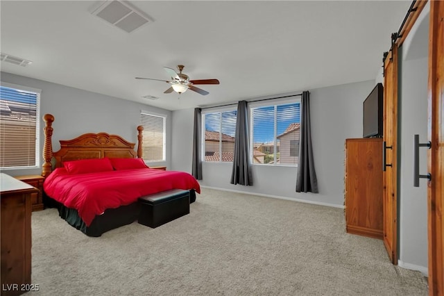9131 Grand Sunburst Ct, Las Vegas, NV 89149 - bedroom with a barn door, carpet floors, multiple windows, and ceiling fan