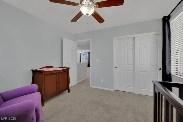 9131 Grand Sunburst Ct, Las Vegas, NV 89149 - bedroom featuring light colored carpet, multiple windows, ceiling fan, and a closet