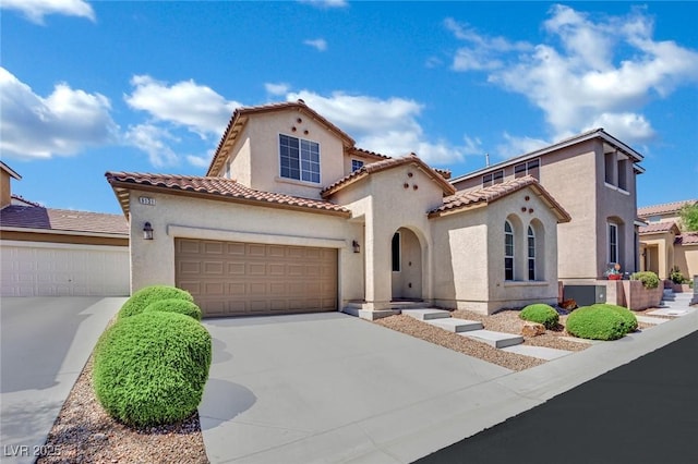 9131 Grand Sunburst Ct, Las Vegas, NV 89149 - mediterranean / spanish house featuring concrete driveway, stucco siding, a garage, and a tile roof