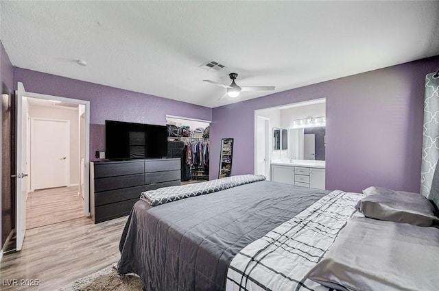 1708 Anzio St, Las Vegas, NV 89108 - bedroom with light wood-style floors, a closet, connected bathroom, and ceiling fan