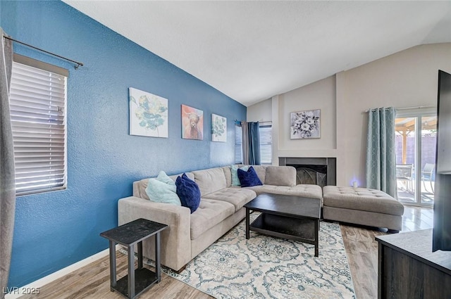 1708 Anzio St, Las Vegas, NV 89108 - living room with vaulted ceiling, a textured wall, wood finished floors, and a fireplace