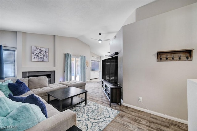 1708 Anzio St, Las Vegas, NV 89108 - living area with vaulted ceiling, a ceiling fan, wood finished floors, and a fireplace