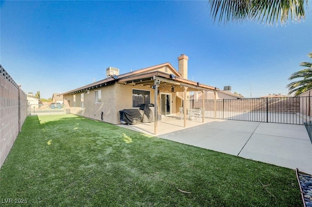 1708 Anzio St, Las Vegas, NV 89108 - back of property with a fenced backyard, stucco siding, a patio, and a chimney