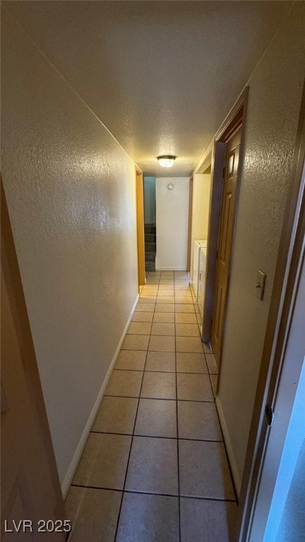 3412 Mercury St Unit I, North Las Vegas, NV 89030 - hallway with light tile patterned flooring, a textured ceiling, and a textured wall